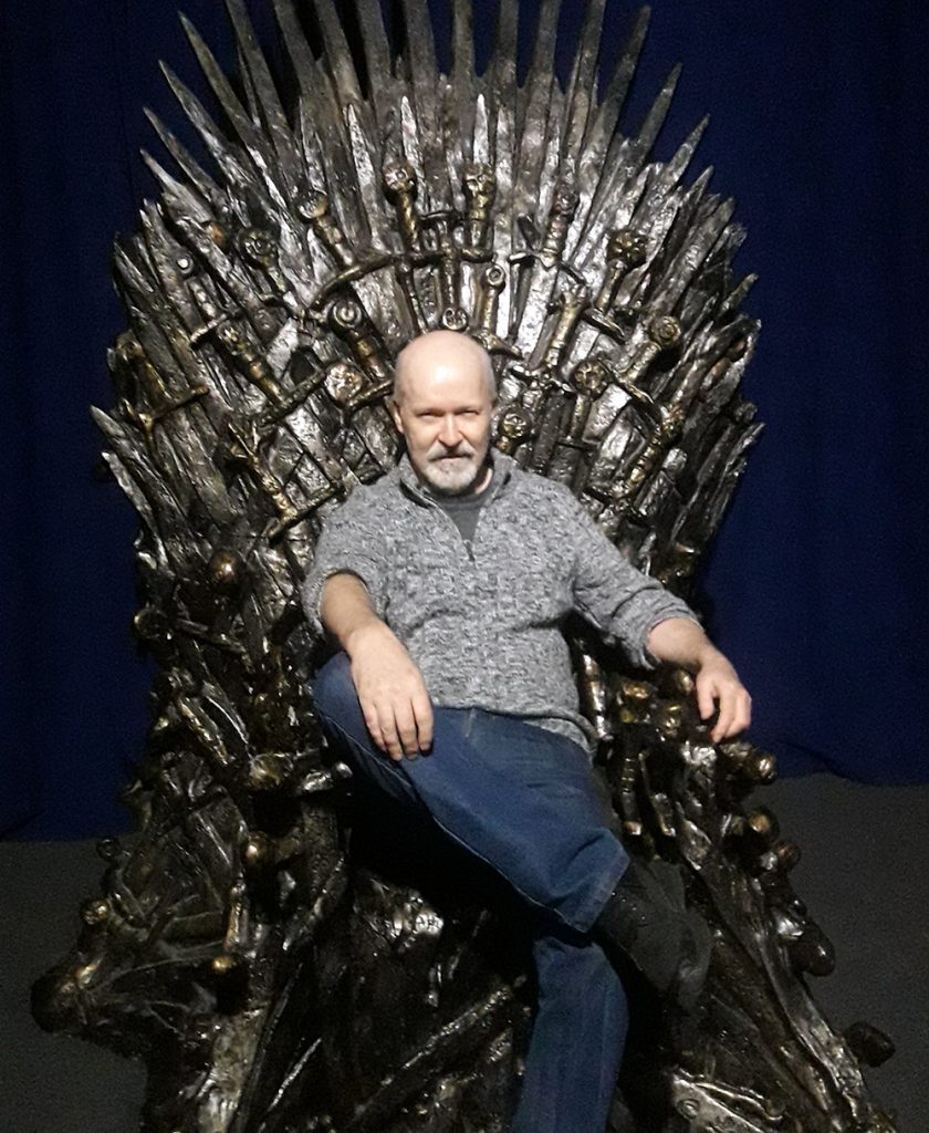 Michael Carroll, sitting on the Iron Throne of the Seven Kingdoms